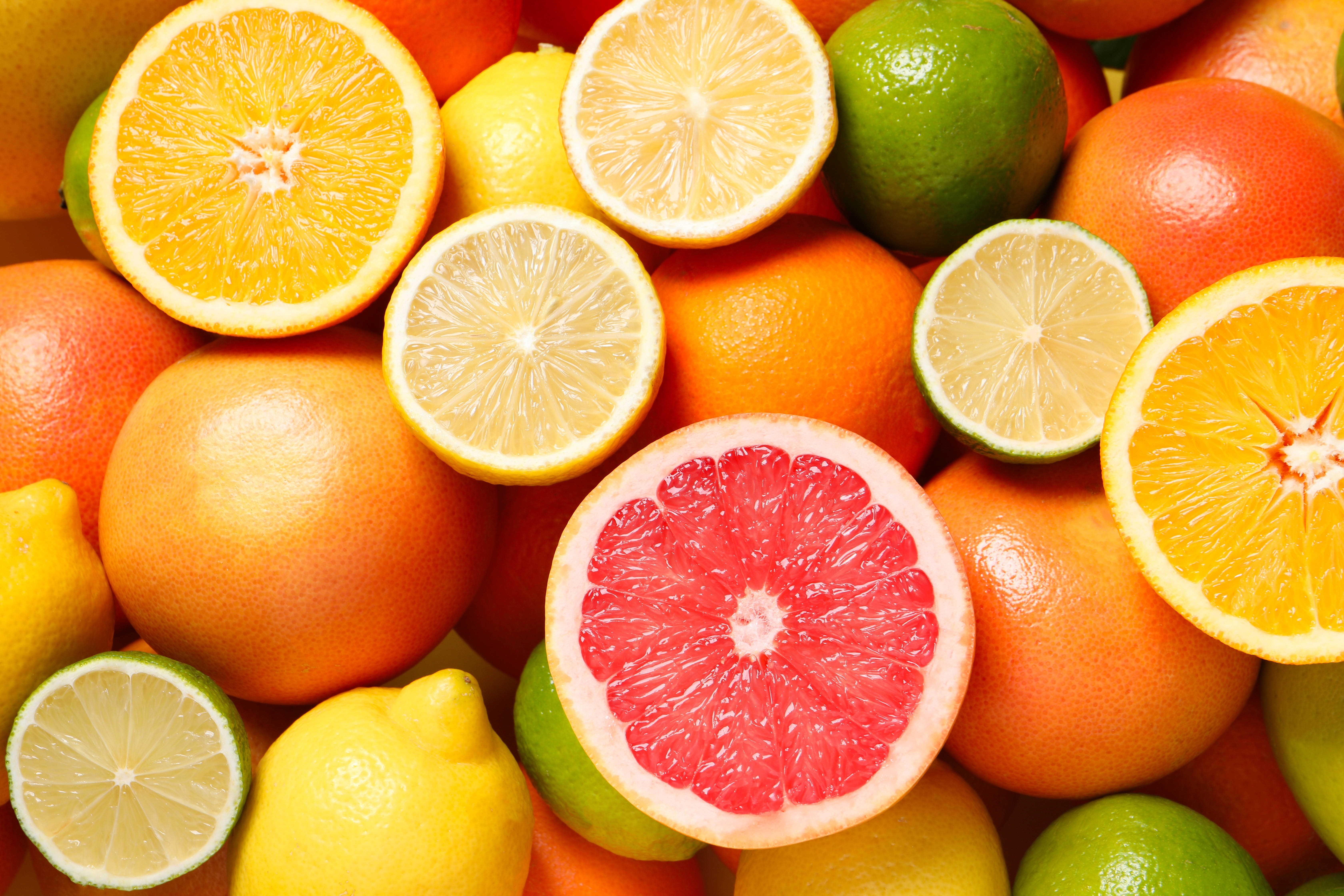 Pile of citrus fruits including grapefruits, oranges, limes, and lemons